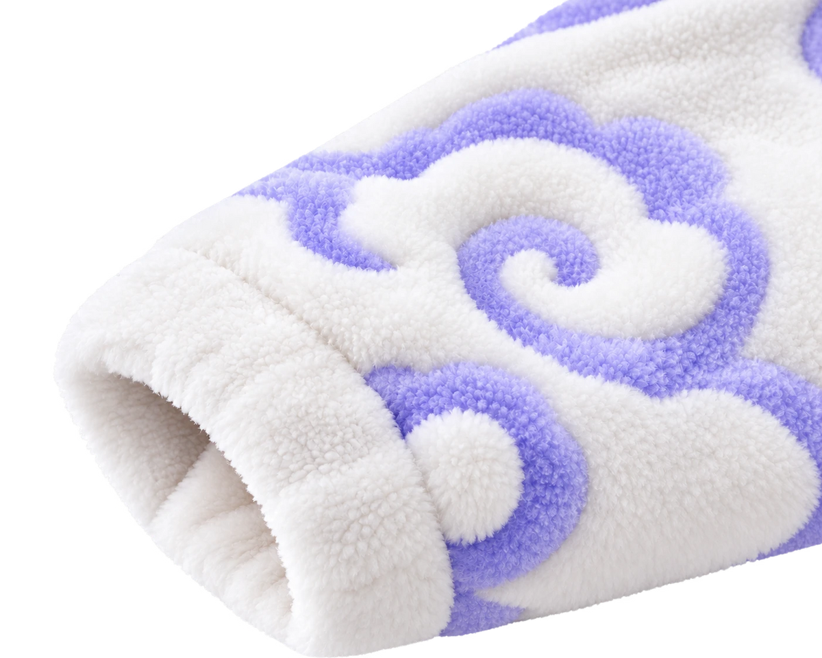 Close-up of the Awakened Cloud Onesie cuff showing the plush texture and raised lavender cloud pattern